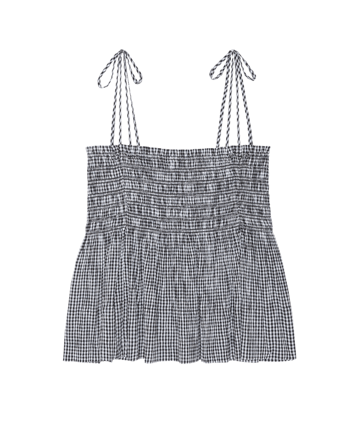 The Tide Smocked Top by THE GREAT. SP26 SWIM features black & cream check with adjustable tie straps—perfect for a chic, casual look. Shown on a white background.