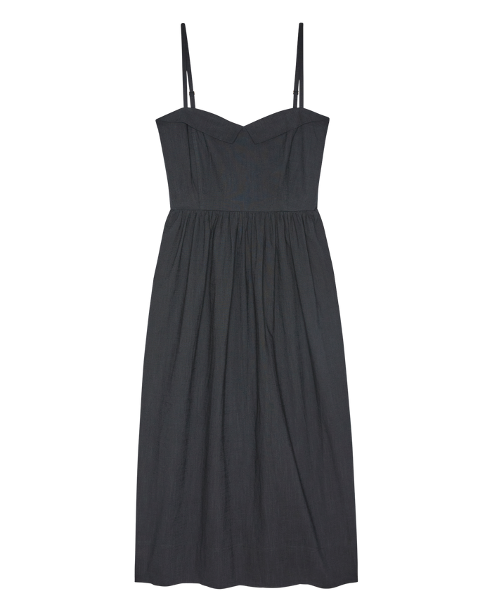 The Verse Dress in black by THE GREAT. SP26 D1 features a sleeveless design with spaghetti straps, a fitted bodice, and a gathered skirt, shown laid flat on a white background.