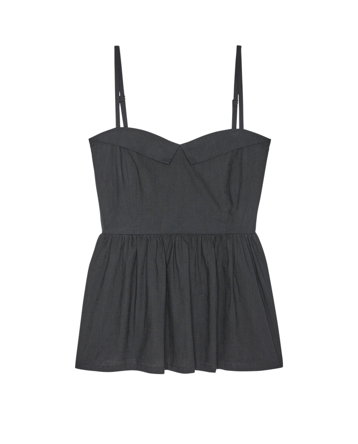 Sleeveless black The Verse Top by THE GREAT. SP26 D1, featuring thin adjustable straps, a fitted bodice, and a flared gathered peplum hem, shown against a plain white background.