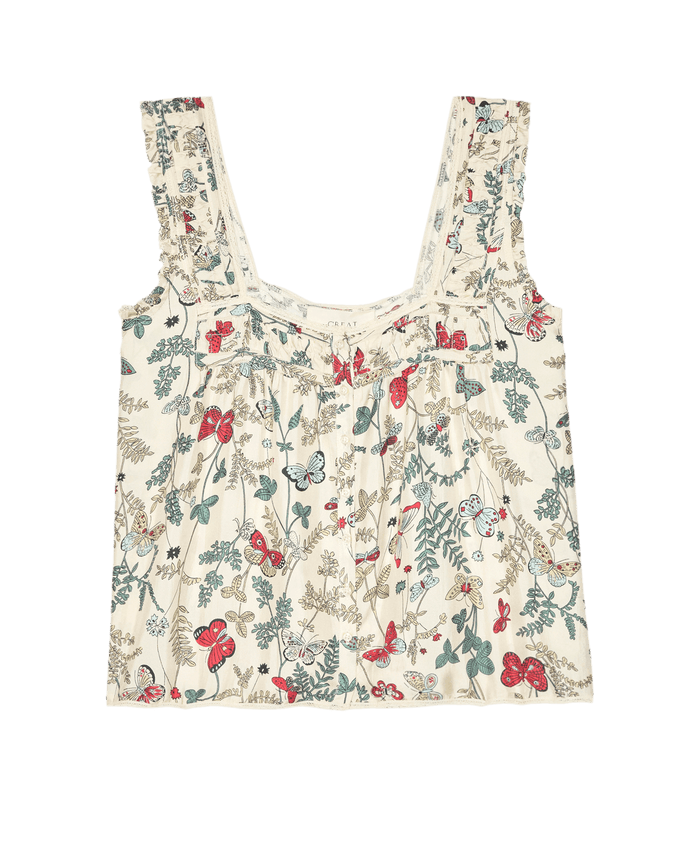 The Victorian Pleat Tank – Floating Butterfly by THE GREAT. features a square neckline and sleeveless design with butterfly, red, blue, and green floral prints on cream silk twill.