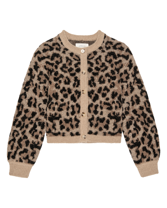 The Windsor Cardigan – Leopard by THE GREAT. H25 COLLECTION is a women's long-sleeve button-up sweater with a beige base and bold black leopard print, shown on a white background.