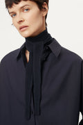 Person wearing a blue navy Woolen Mini Scarf