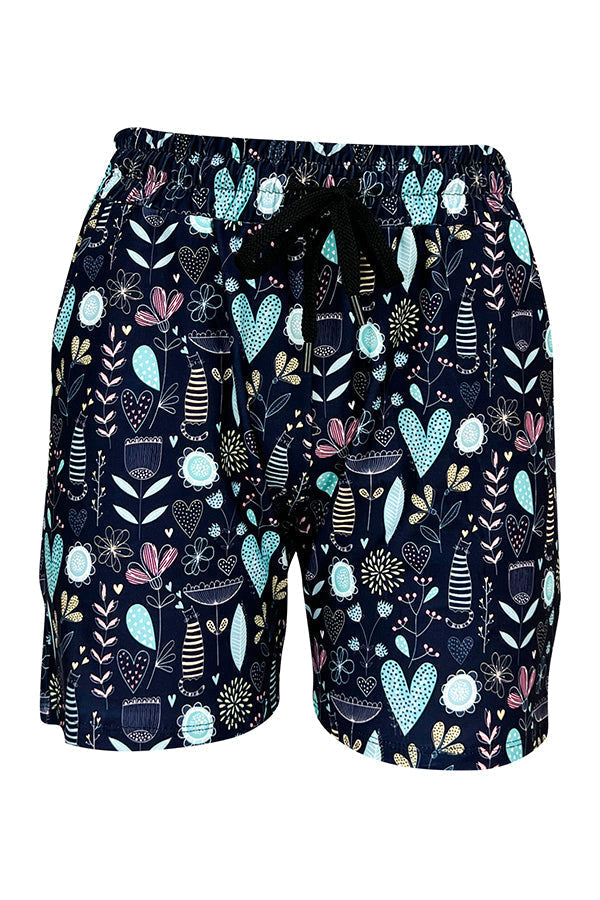 Wildflower Whiskers Jogger Shorts with floral, heart, and striped kitty designs on blue background, elastic waistband, and side pockets.