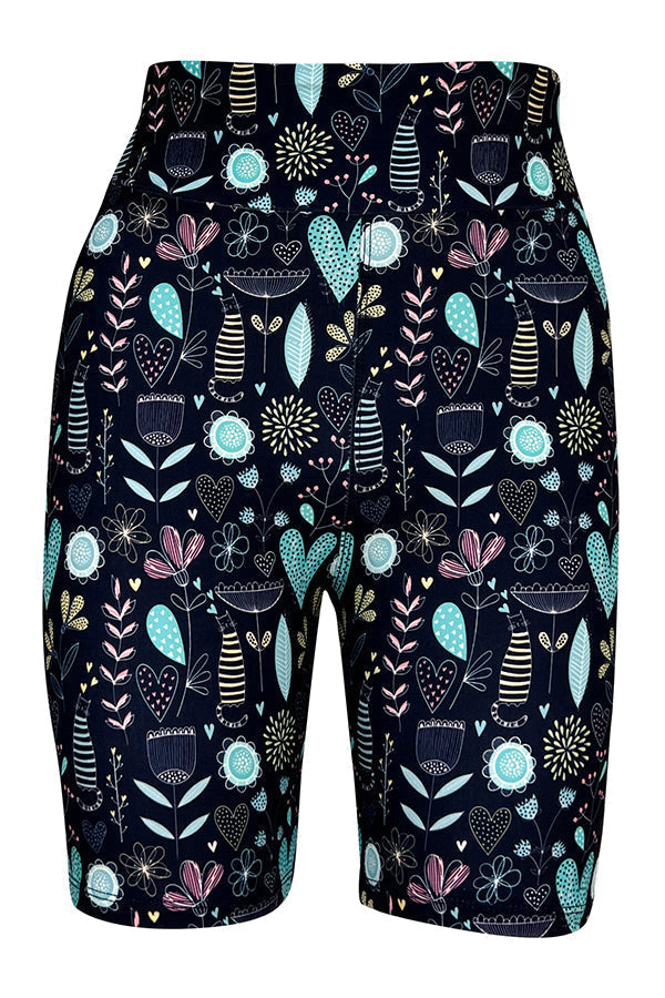 Tight shorts with pastel floral, heart motifs and striped kitty pattern on a dark background for a comfortable and stylish fit