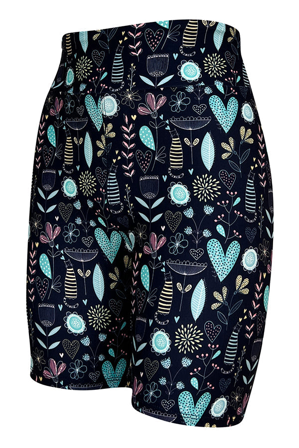 Tight shorts with Wildflower Whiskers floral and striped kitty pattern on a dark background.